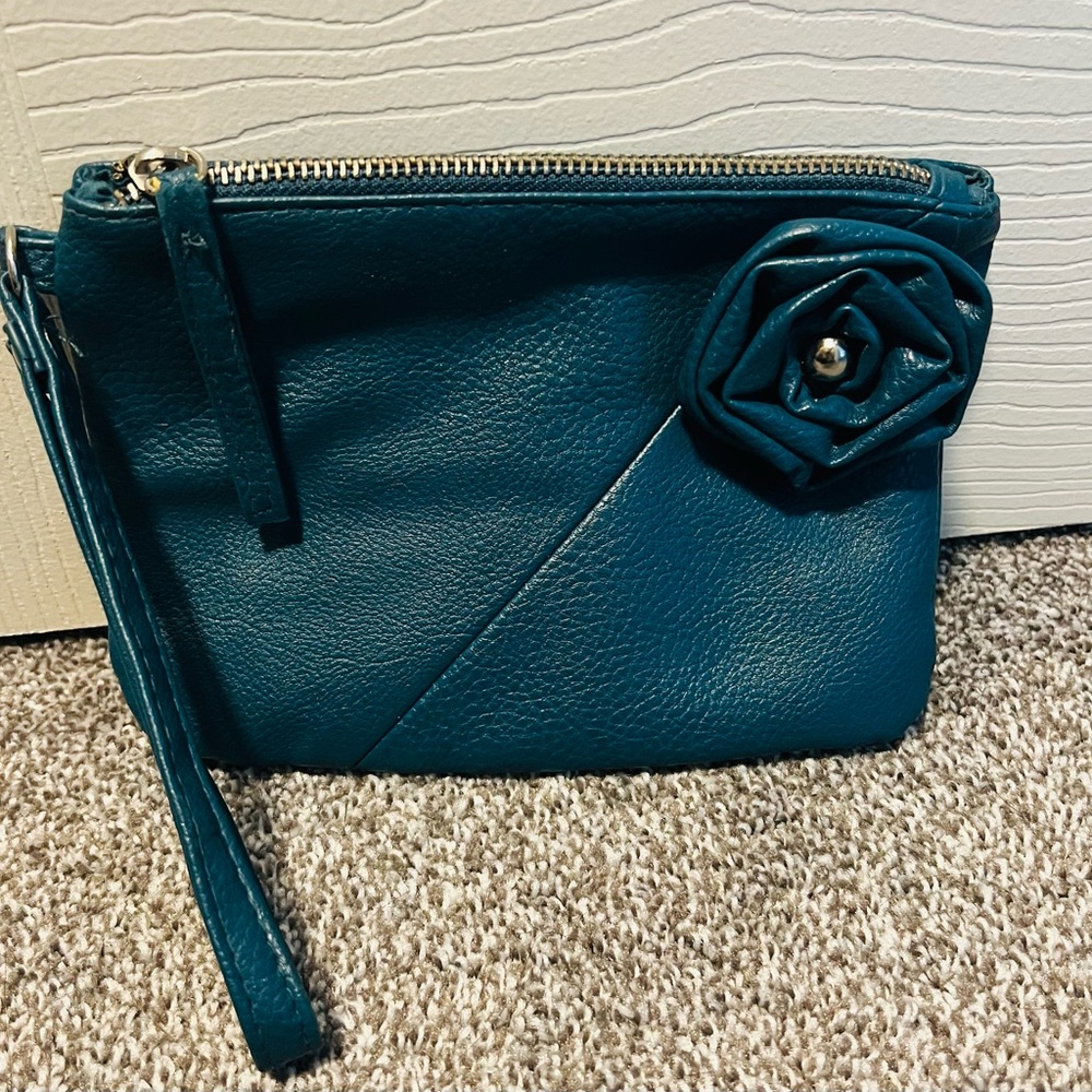 Turquoise wristlet with flower decal and zipper closure